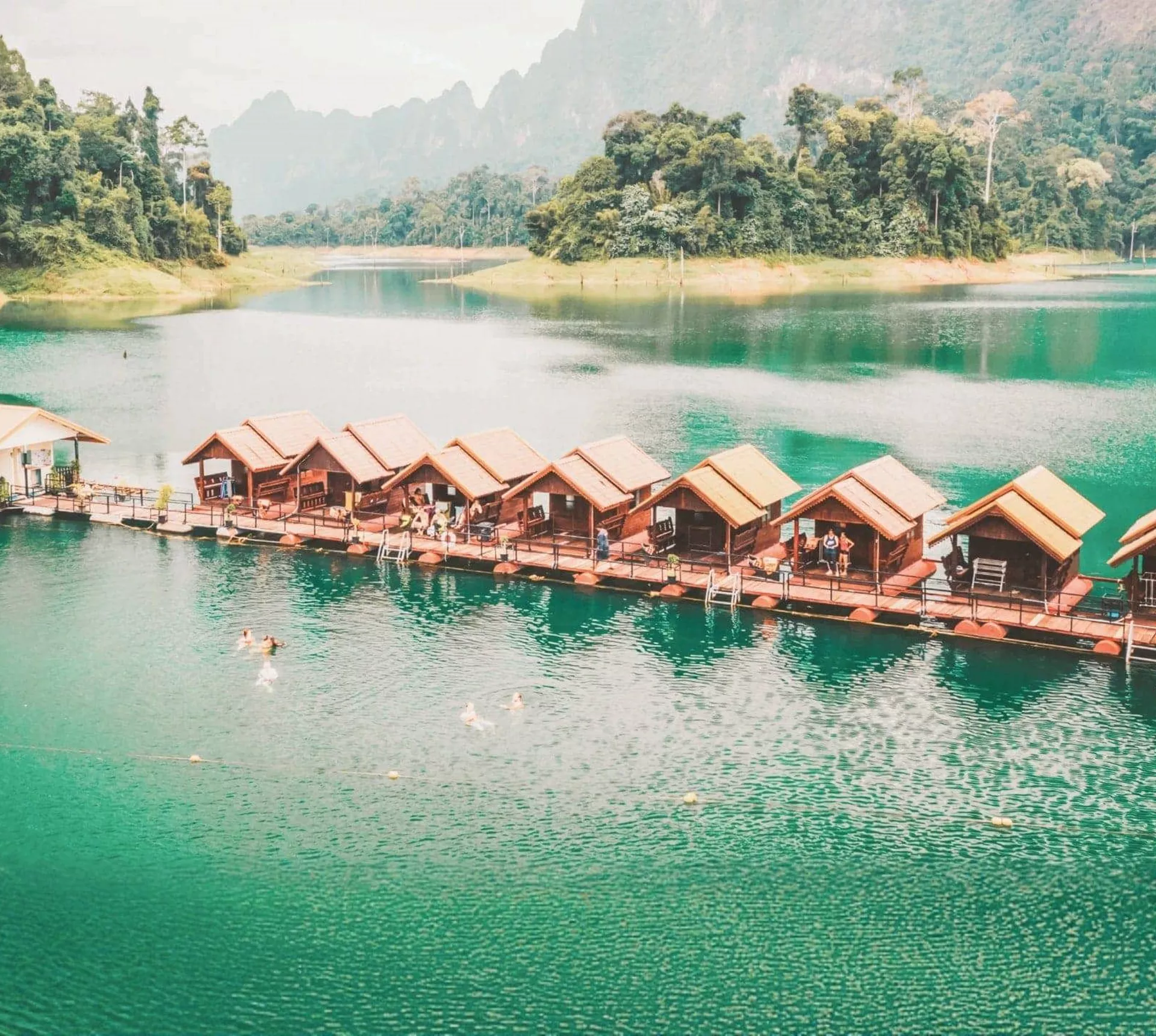 Floating raft houses surrounded by rainforest in Khao Sok National Park - Contiki Southern Thailand to Singapore Tour