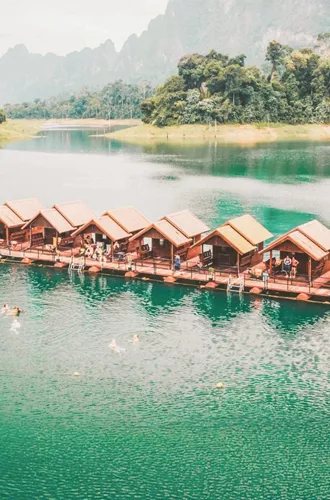 Floating raft houses surrounded by rainforest in Khao Sok National Park - Contiki Southern Thailand to Singapore Tour
