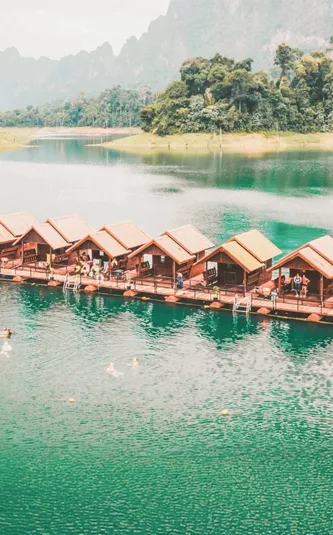 Floating raft houses surrounded by rainforest in Khao Sok National Park - Contiki Southern Thailand to Singapore Tour