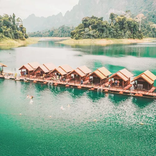 Floating raft houses surrounded by rainforest in Khao Sok National Park - Contiki Southern Thailand to Singapore Tour