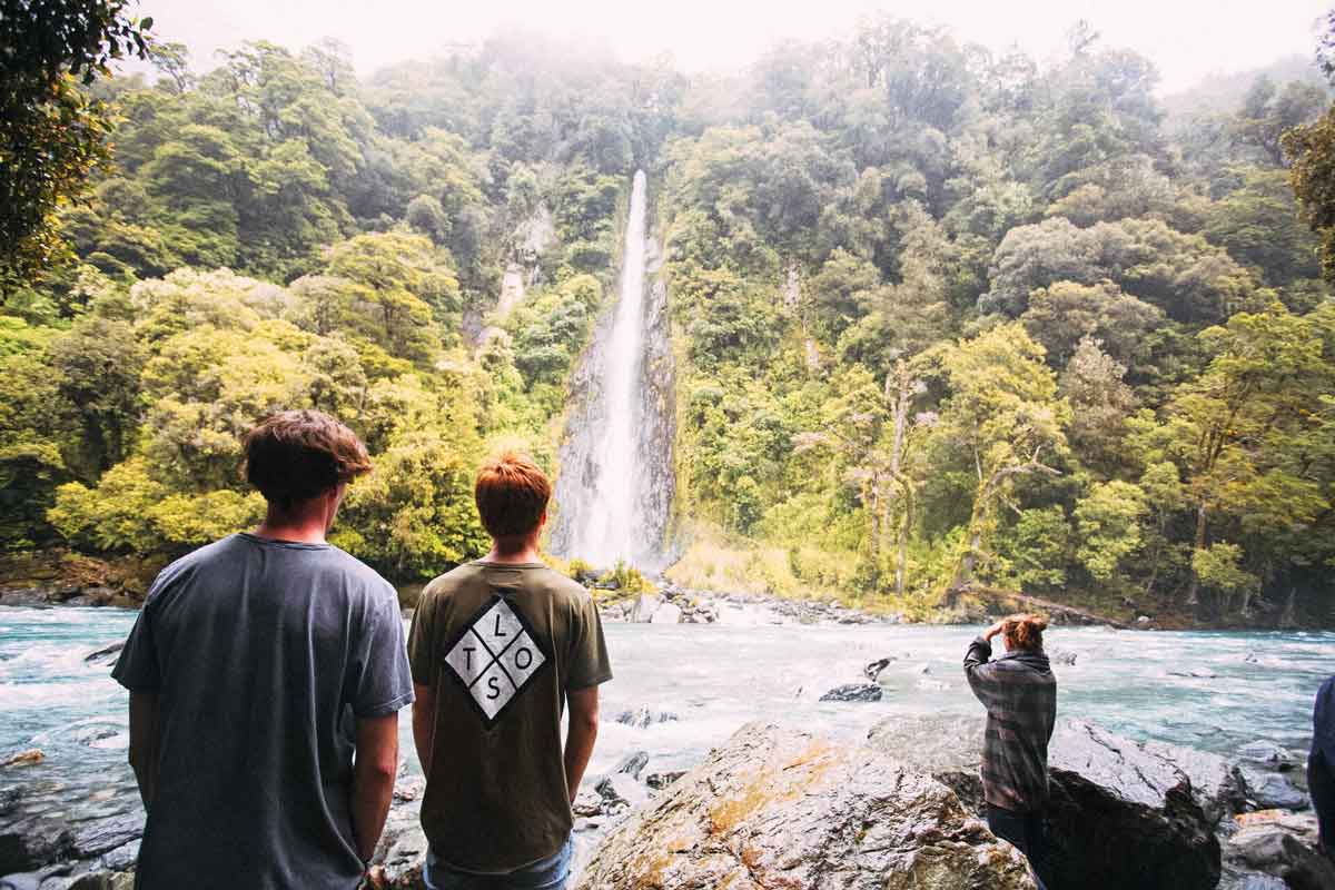 Group In New Zealand Near Waterfall