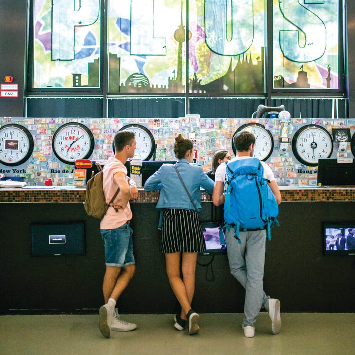 A group of people talking to the receptionist