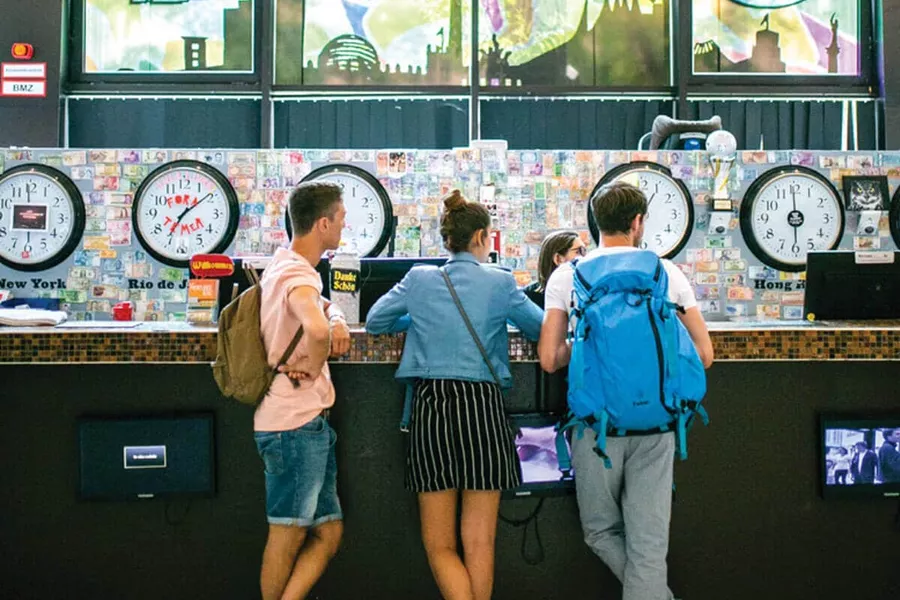 A group of people talking to the receptionist