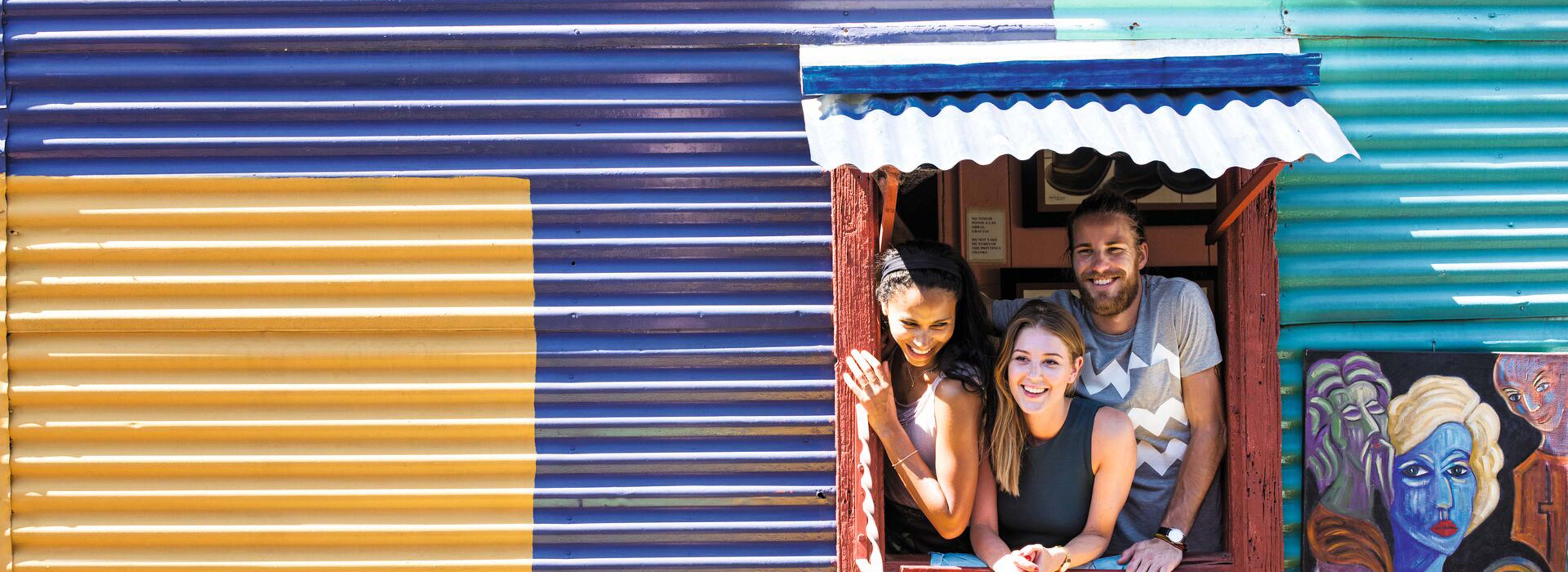 Travellers smiling in La Boca district, Buenos Aires