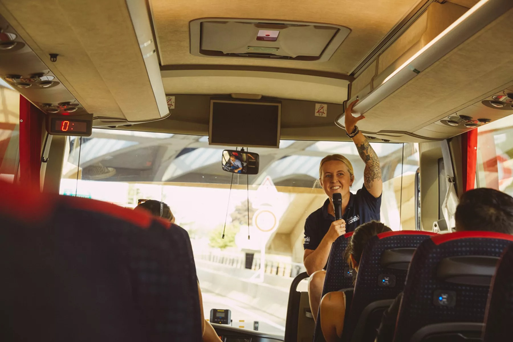 Trip Manager talking to people in a bus
