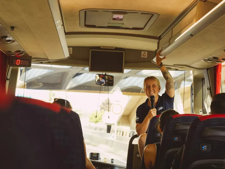 Trip Manager talking to people in a bus