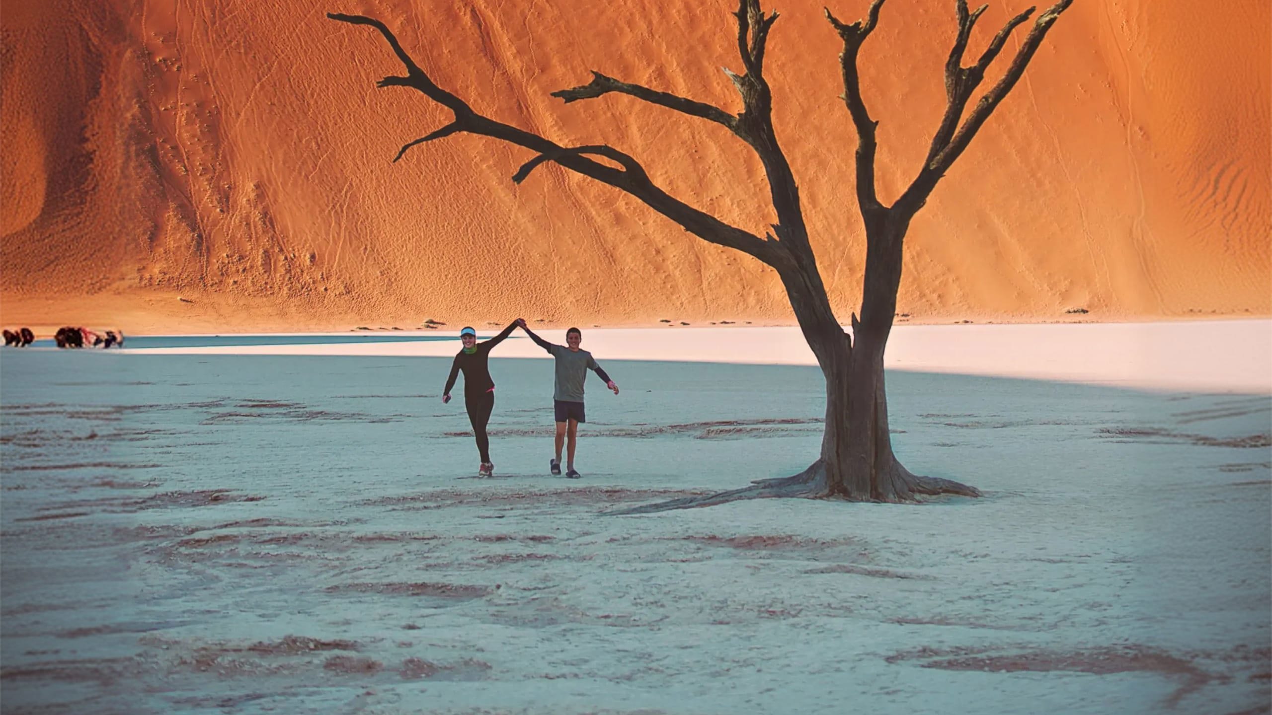 Travellers walking through Deadvlei in Namib-Naukluft National Park, Namibia - Contiki Best of Namibia Tour