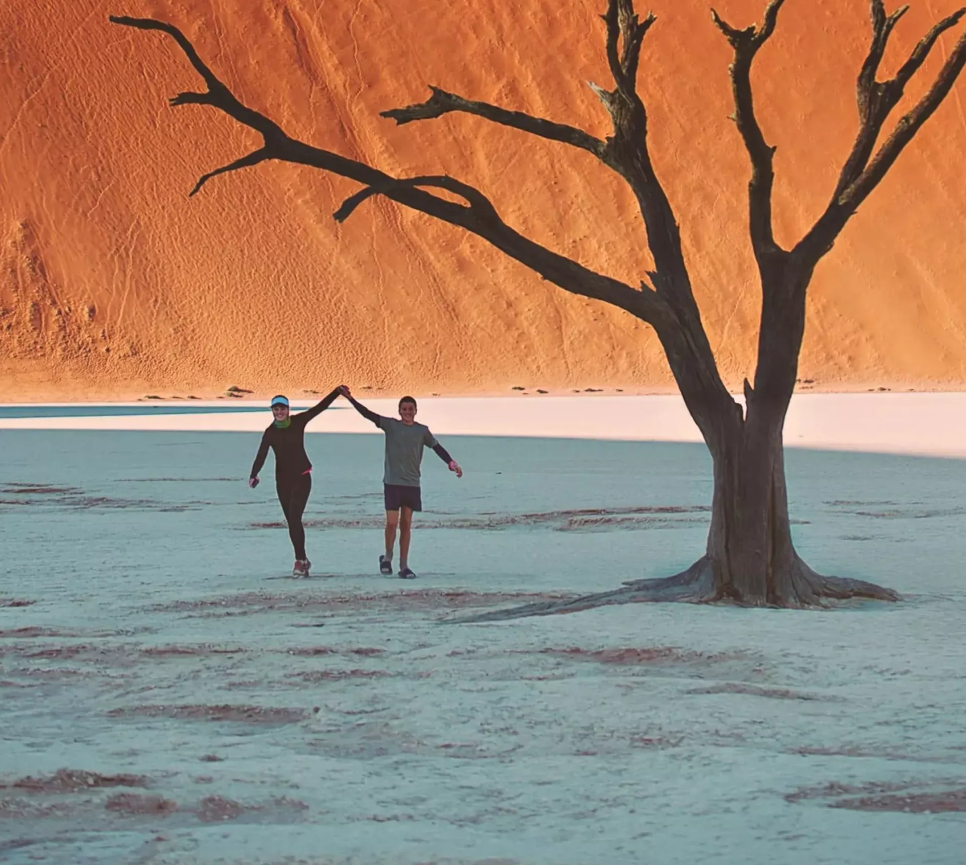 Travellers walking through Deadvlei in Namib-Naukluft National Park, Namibia - Contiki Best of Namibia Tour