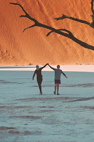 Travellers walking through Deadvlei in Namib-Naukluft National Park, Namibia - Contiki Best of Namibia Tour