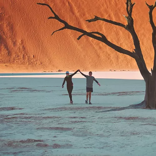 Travellers walking through Deadvlei in Namib-Naukluft National Park, Namibia - Contiki Best of Namibia Tour