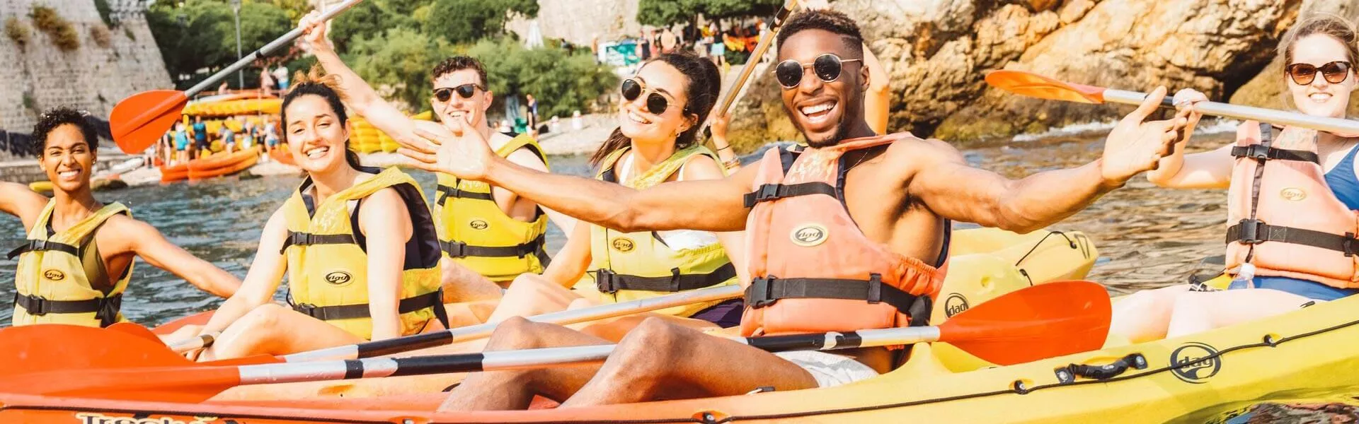 Group kayaking around Dubrovnik in the sun