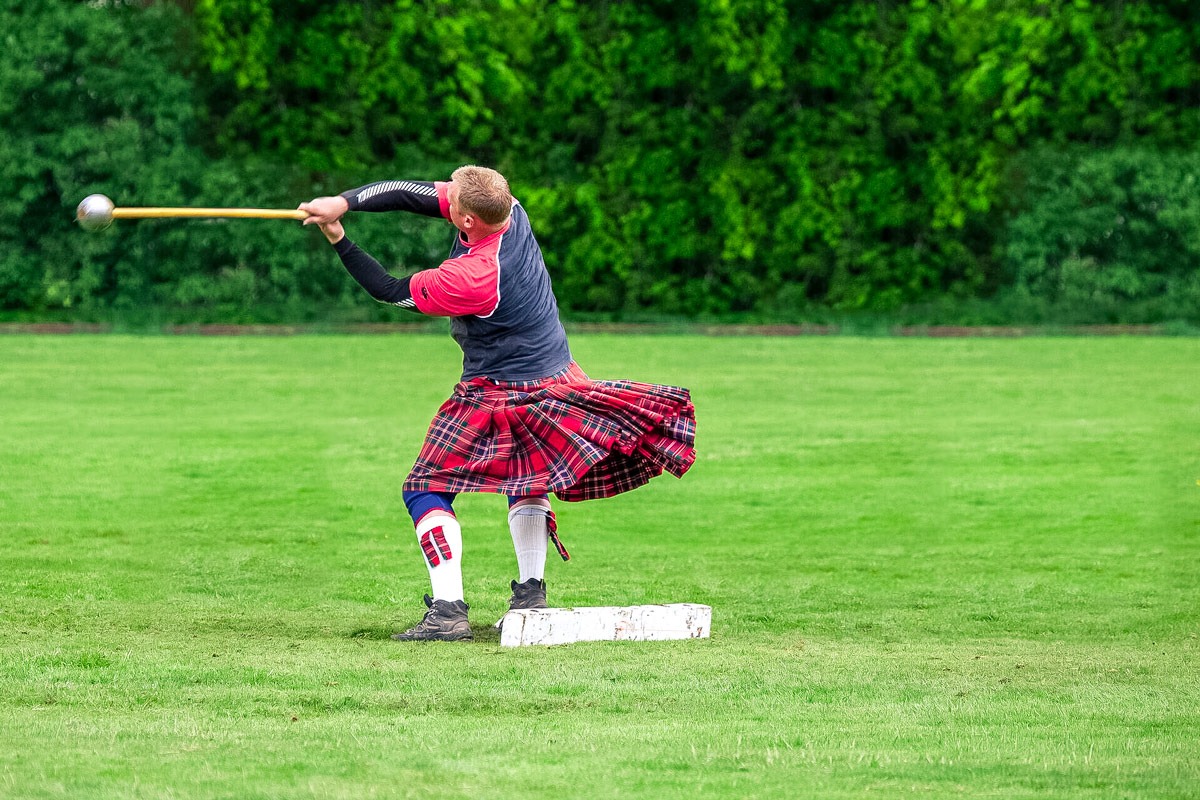 Man participating at highland games.
