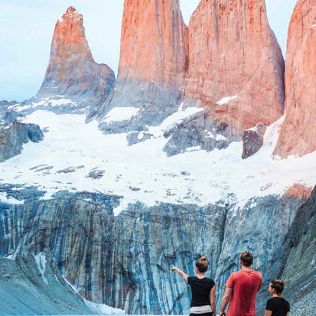 Three People Looking At Red Mountains