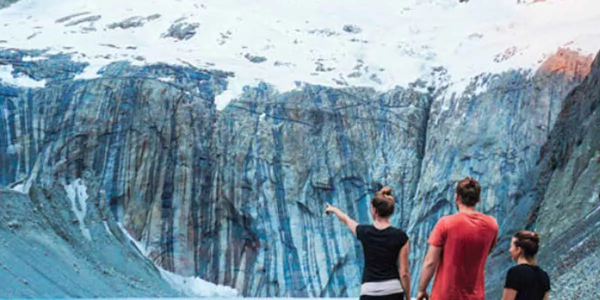 Three People Looking At Red Mountains