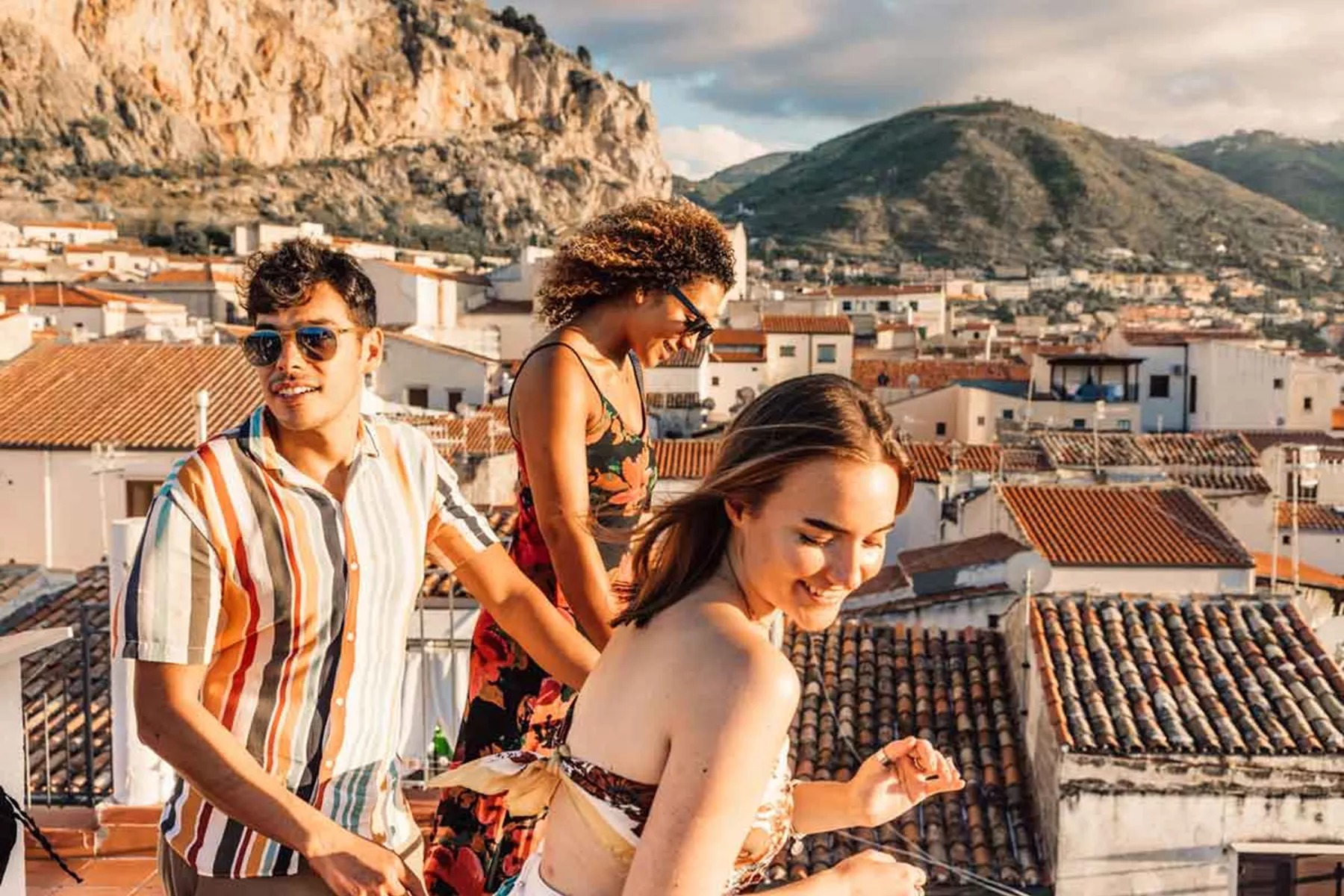 Trio Of Young Travelers On Rooftops In Sicily 