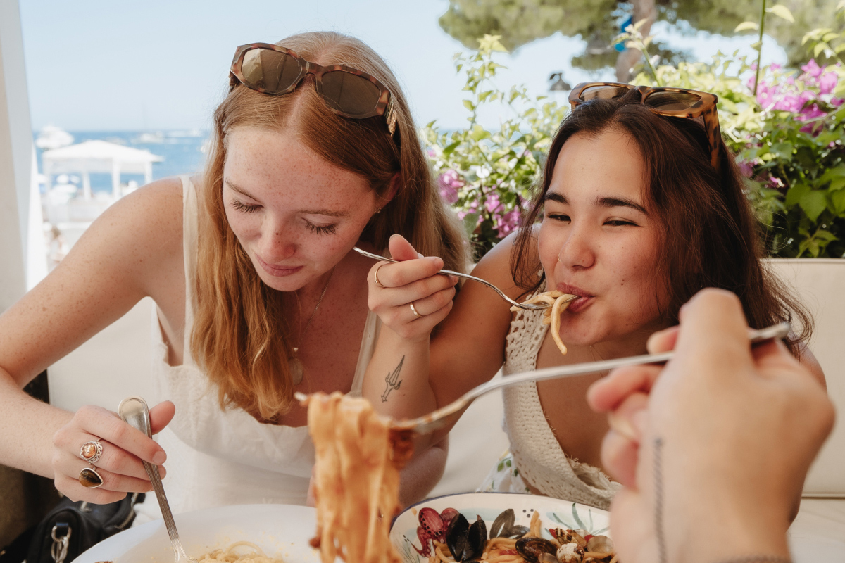 faq-tile-two-women-eating-pasta-in-sorrento-italy.jpg