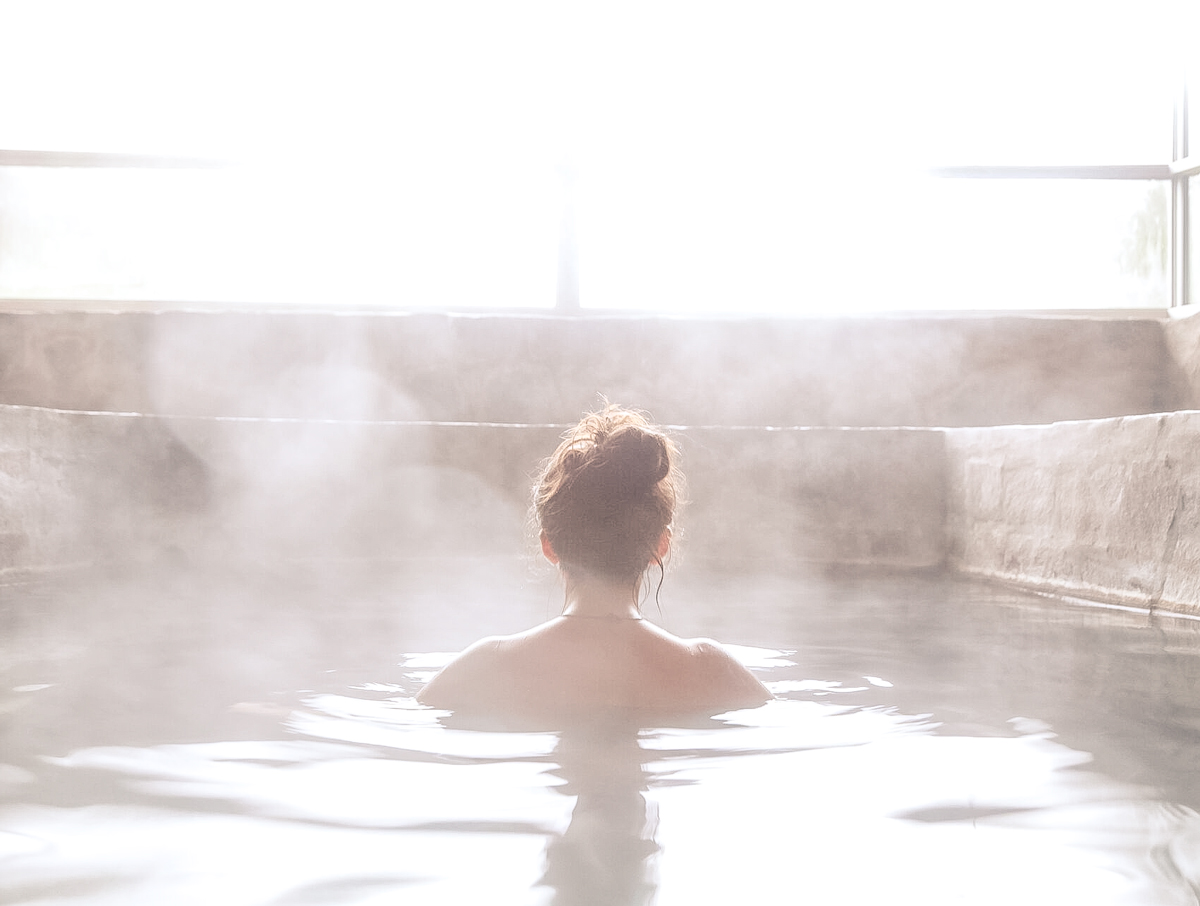Woman In An Outdoor Bath With Steam