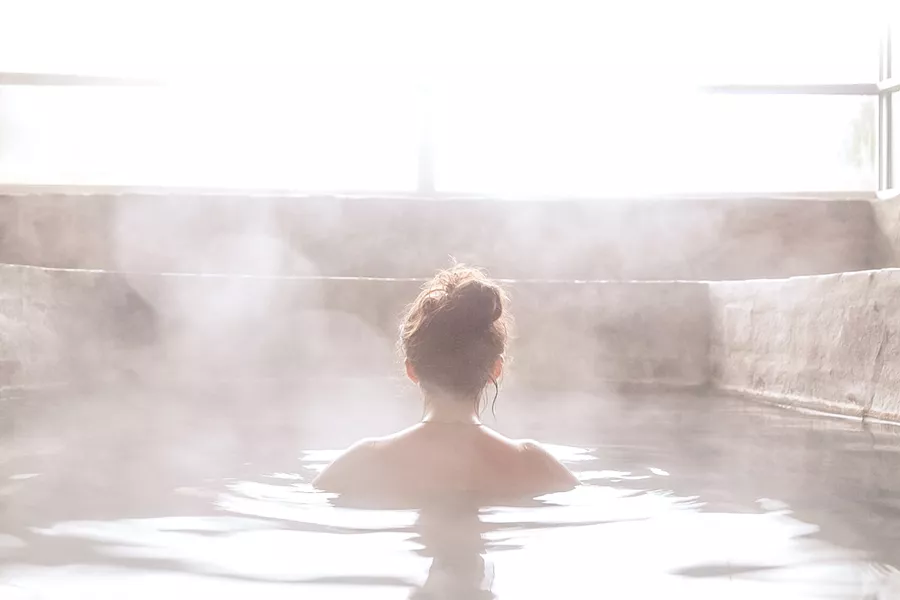 Woman In An Outdoor Bath With Steam