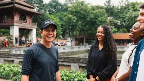 People Smiling Temple At The Back Green Trees