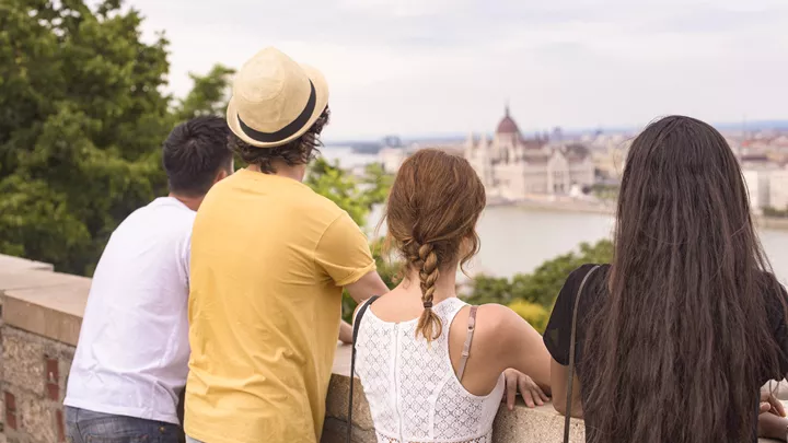 Travellers overlooking the Danube at the Hungarian Parliament House in Budapest, Hungary
