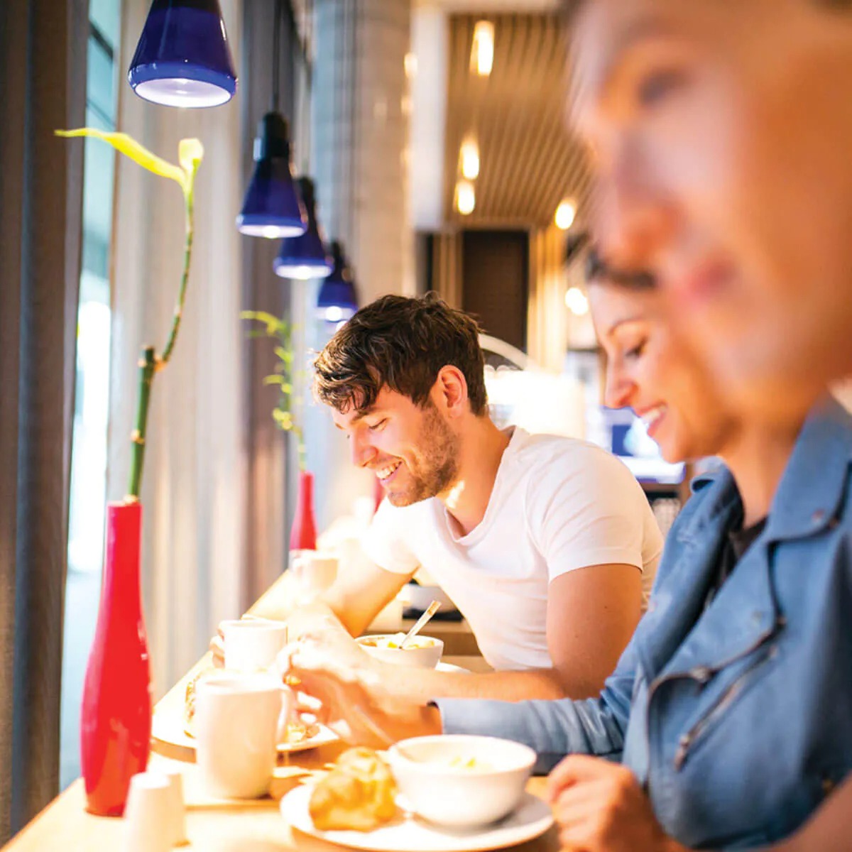 Tourists enjoying breakfast in Plus Hostel Berlin