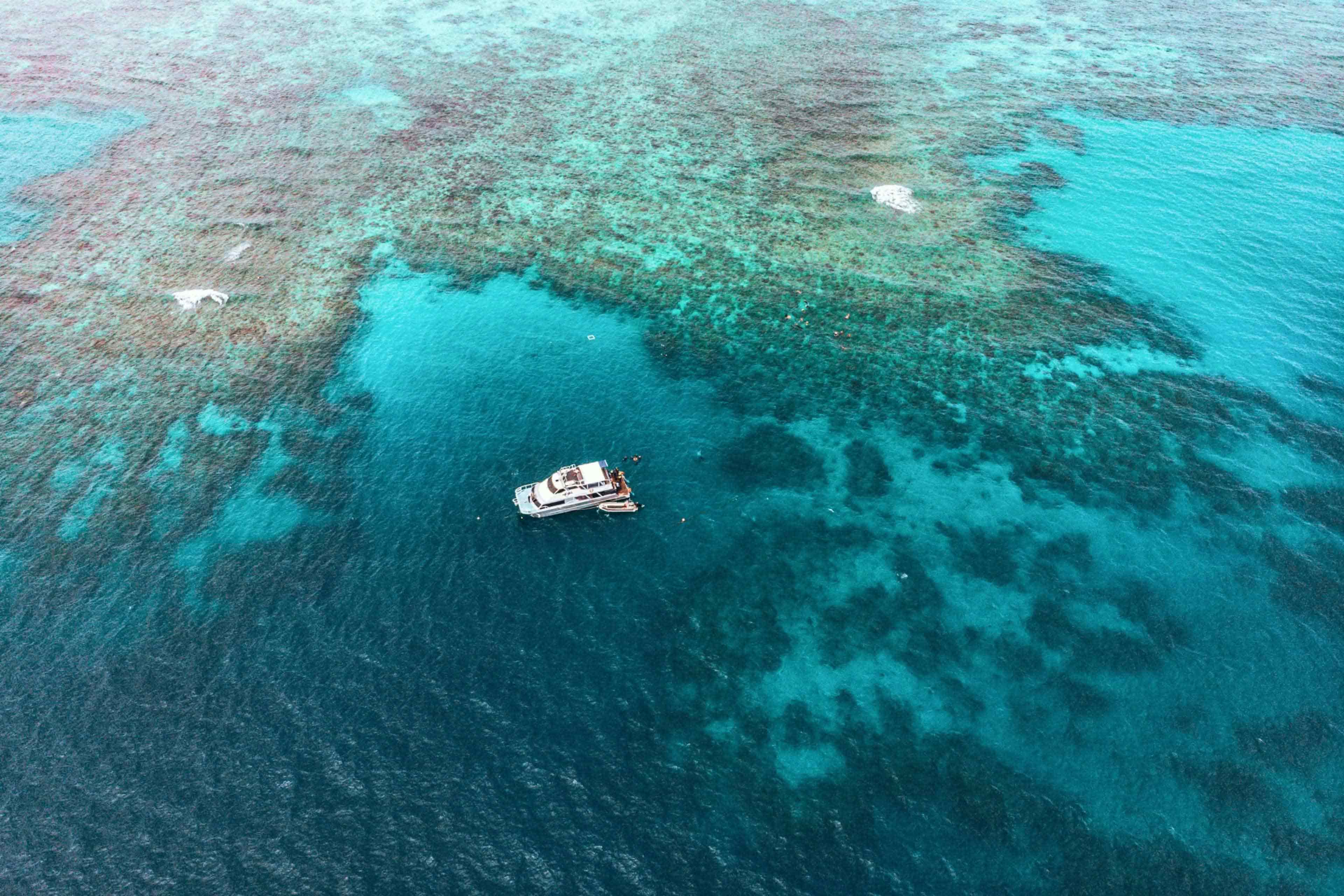 Aerial view of a boat anchored on the Great Barrier Reef off the Queensland coast, Australia.