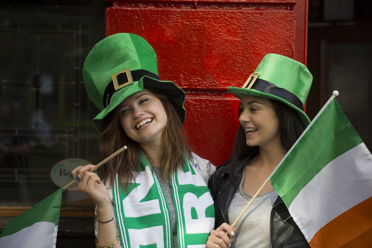 Two Girls Wearing Irish Hats Holding Irish Flags