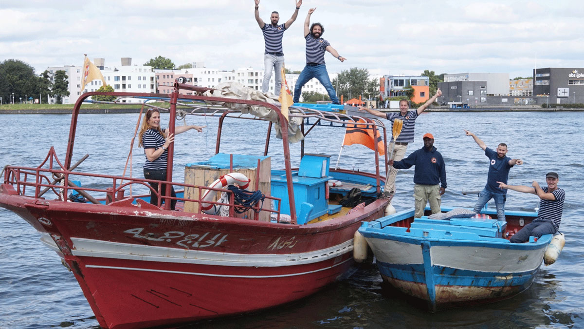 A group of people standing on top of a boat