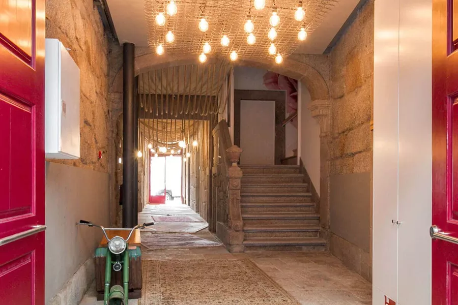 Corridor with stairs and a chandelier