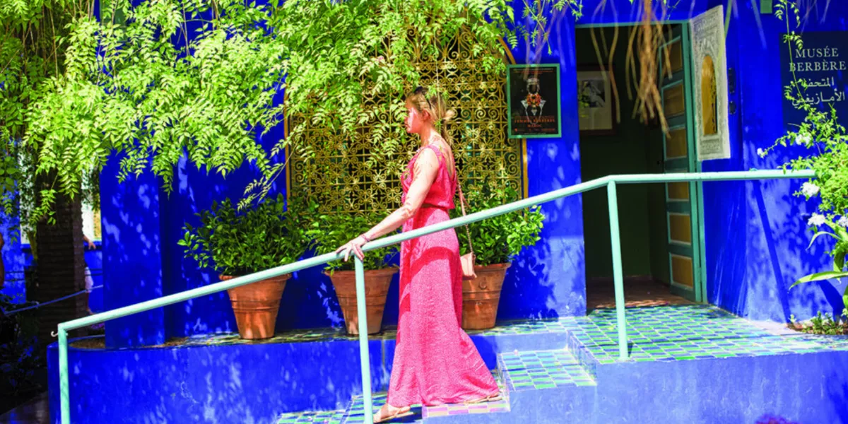 Woman Walking Downstairs Blue Walls Green Plants Around