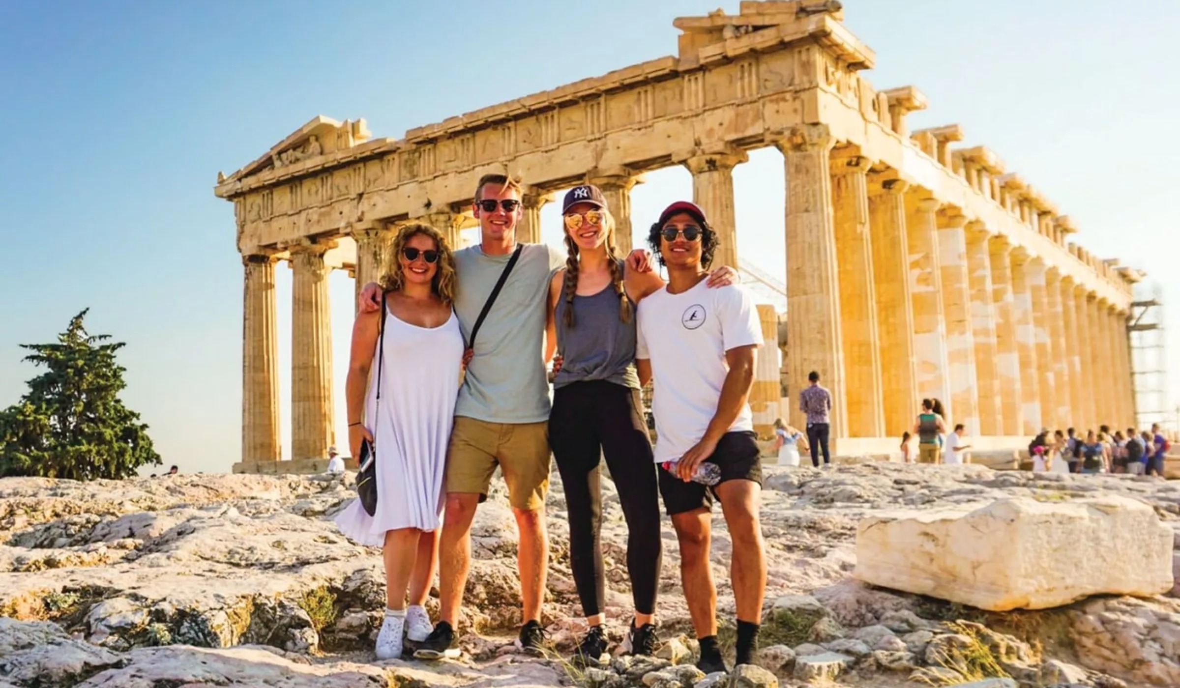 Travellers with Acropolis in background, Athens, Greece