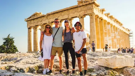 Travellers with Acropolis in background, Athens, Greece