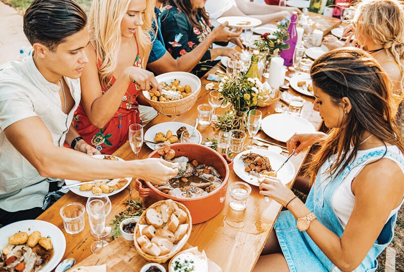 Food Experiences, travellers eating traditional Cassoulet in France