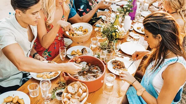 Food Experiences, travellers eating traditional Cassoulet in France