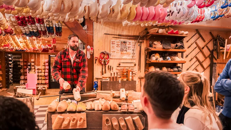 Travellers watching a clog maker in Edam, Netherlands