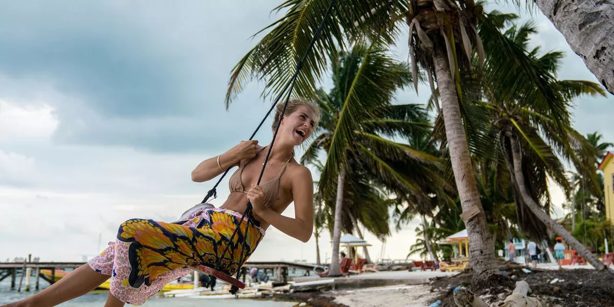 Girl On Swing On Beach In Belize