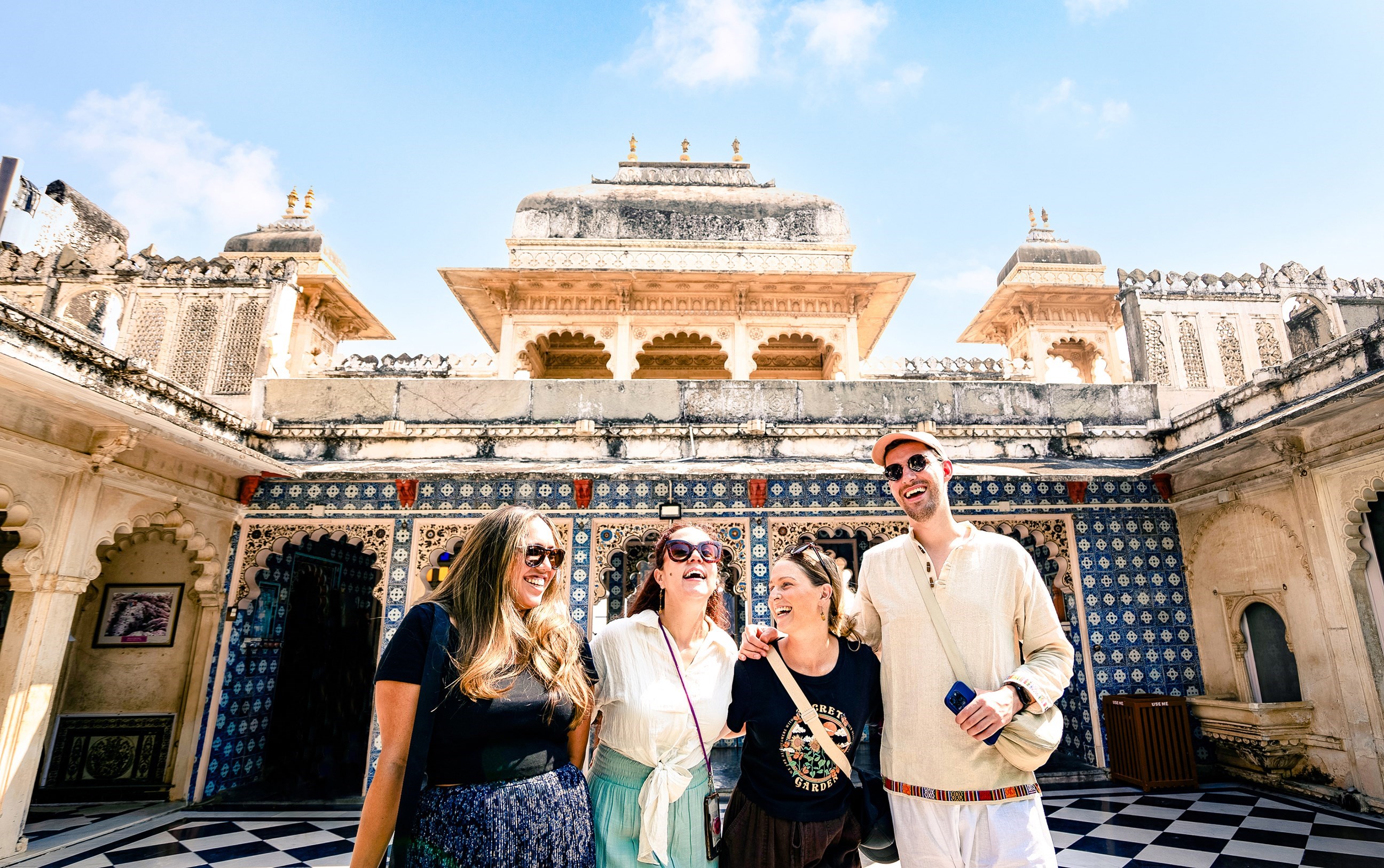 Four travellers standing in the middle of the Amer Fort in Jaipur, India
