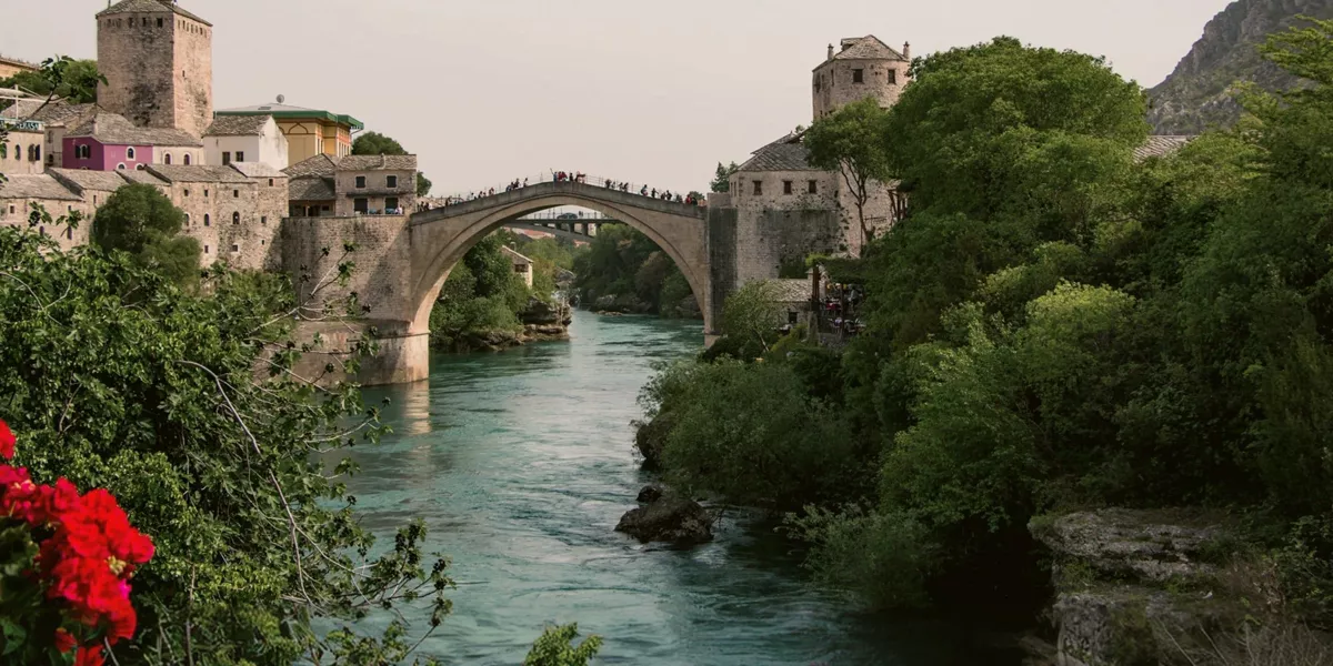 The iconic Stari Most bridge spans the Neretva River on the Contiki Dubrovnik to Budapest Tour