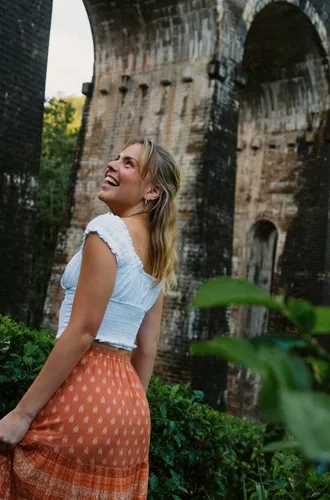Female admiring the Nine Arch Bridge surrounded by lush forest in Ella, Sri Lanka - Contiki Best of Sri Lanka Tour