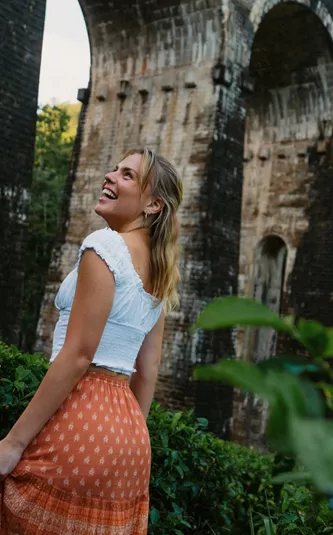 Female admiring the Nine Arch Bridge surrounded by lush forest in Ella, Sri Lanka - Contiki Best of Sri Lanka Tour