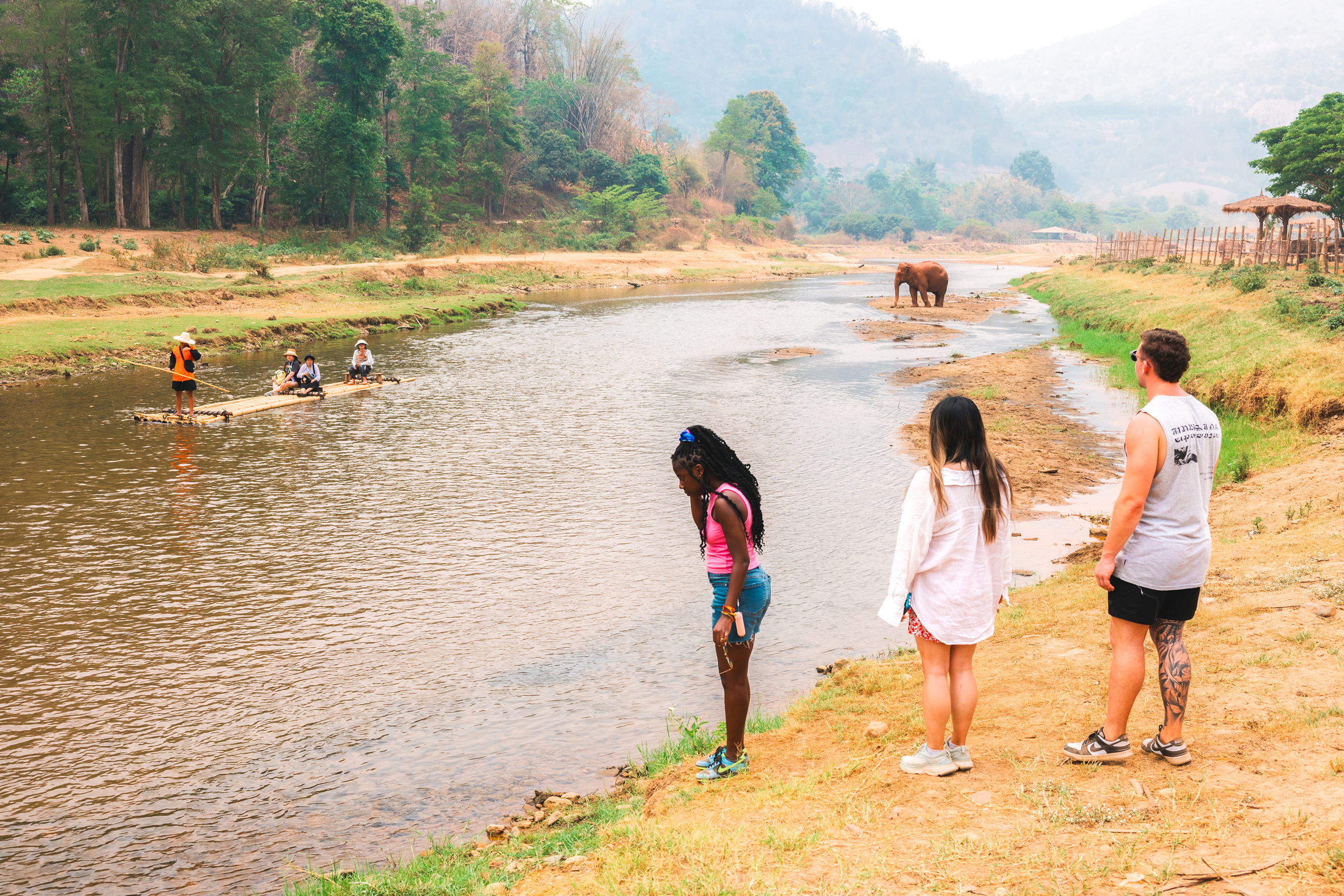 Travellers watching elephants and rafting at Elephant Nature Park, Chiang Mai, Thailand