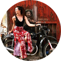 A woman in a dress sitting on a motorcycle