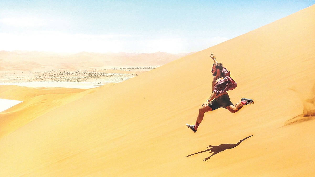 Man jumping desert, Namibia.