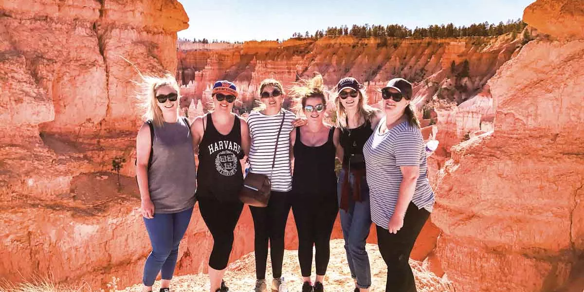 Group Of Young Travelers At Bryce Canyon National Park Usa