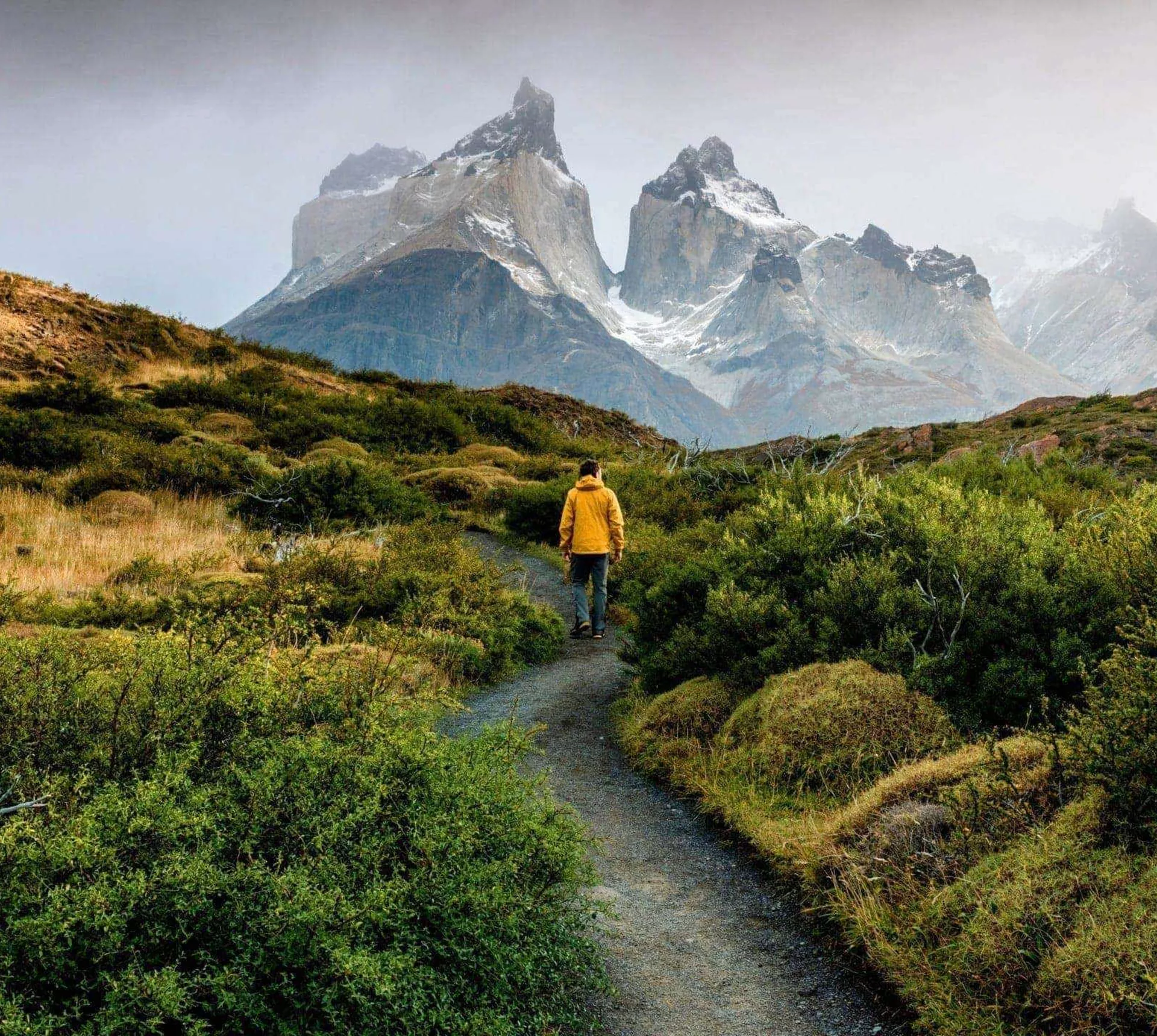 Traveller hiking through Patagonia with dramatic mountain peaks on the Contiki Active Patagonia Tour