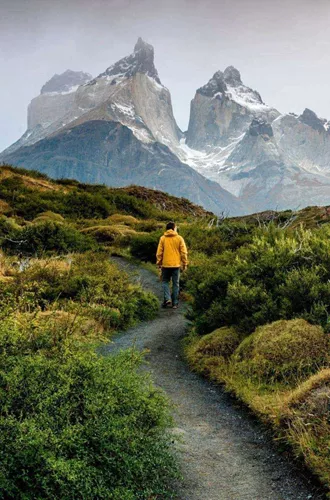 Traveller hiking through Patagonia with dramatic mountain peaks on the Contiki Active Patagonia Tour