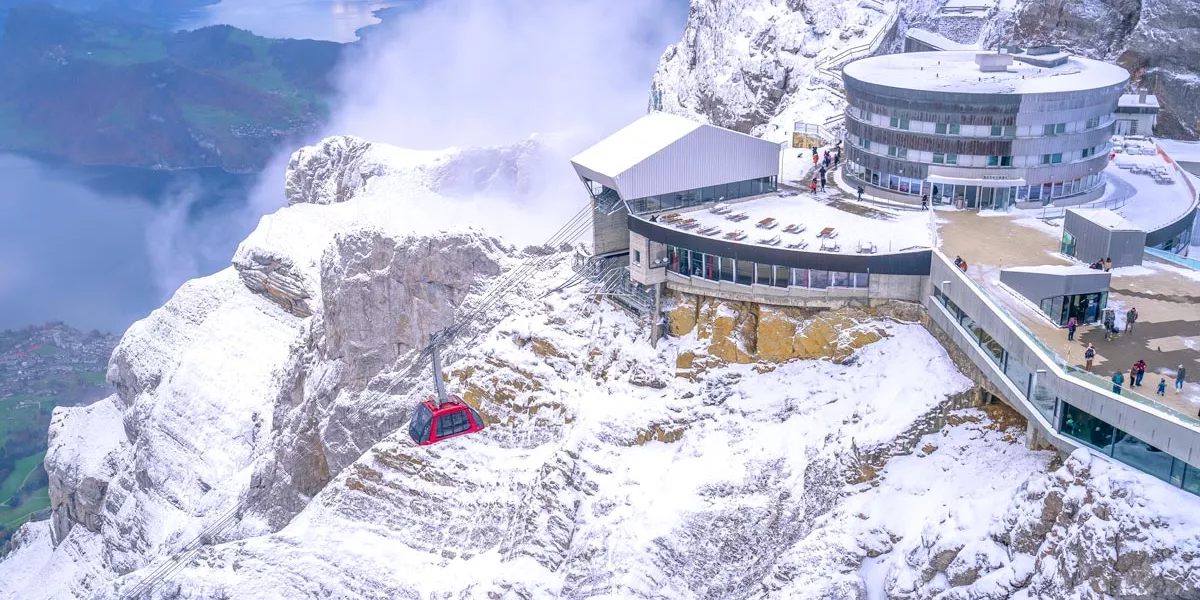 Building At The Top Of A Mountain Covered By Snow