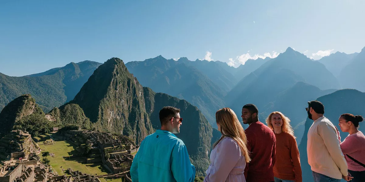 Friends Smiling At Each Other Mountains Landscape At The Back
