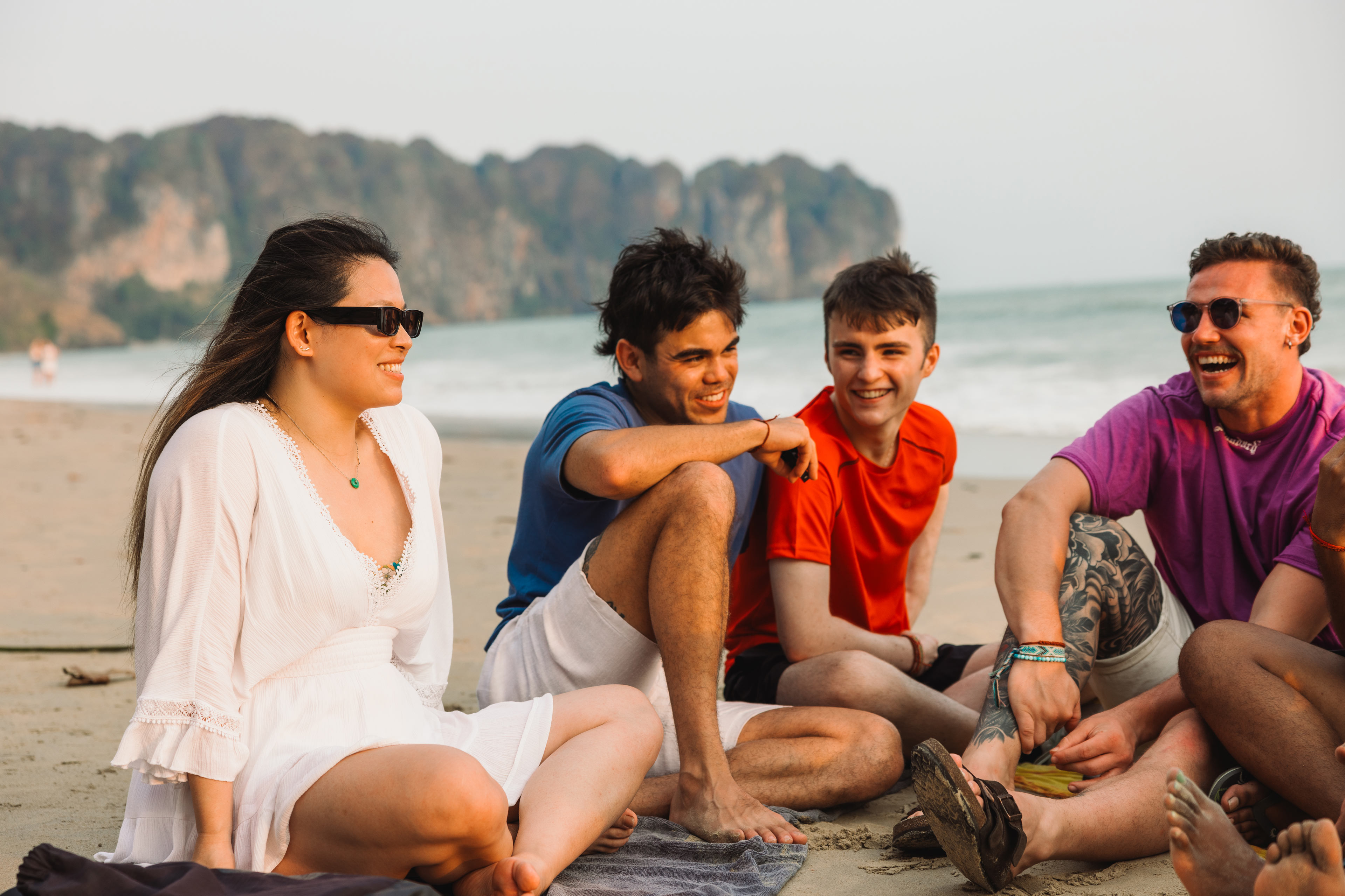 Group Sat On Beach In Thailand