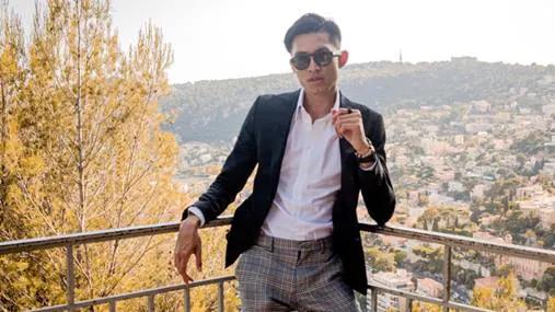 A smartly dressed man posing for a photo